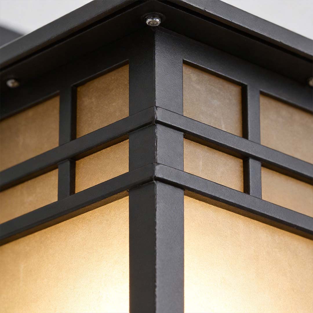 Vintage wall lantern with a close-up of its mounting bracket and design.