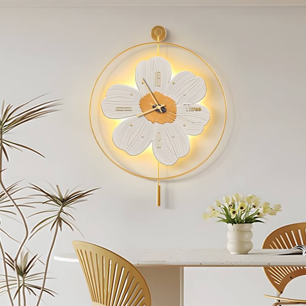 Wall clock with light, close-up view of its gold mount and floral design.