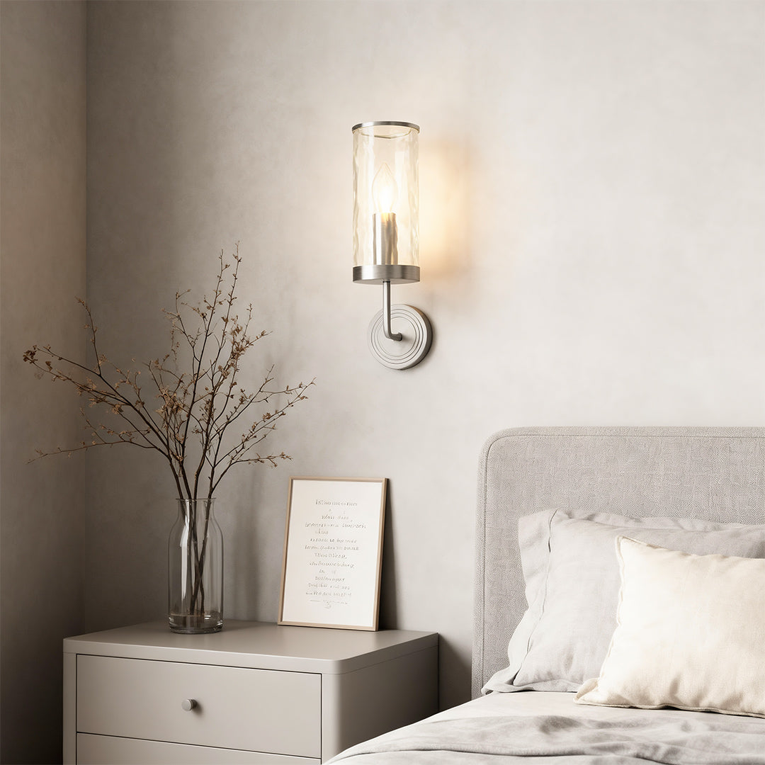 Wall glass light providing bedside illumination in serene bedroom with neutral tones.