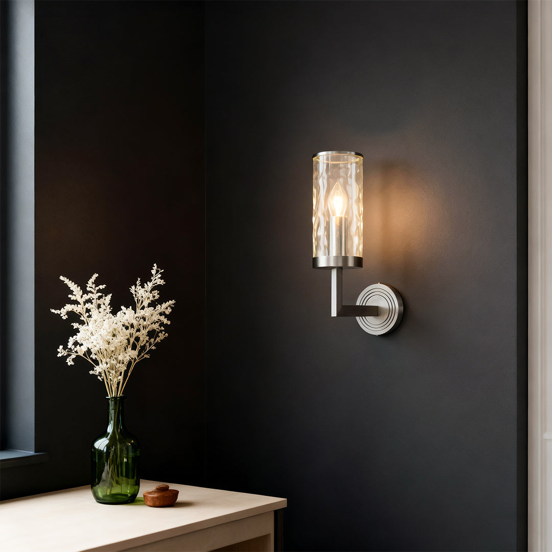 Modern luxury chandeliers style wall glass light creating moody ambiance against dark wall.