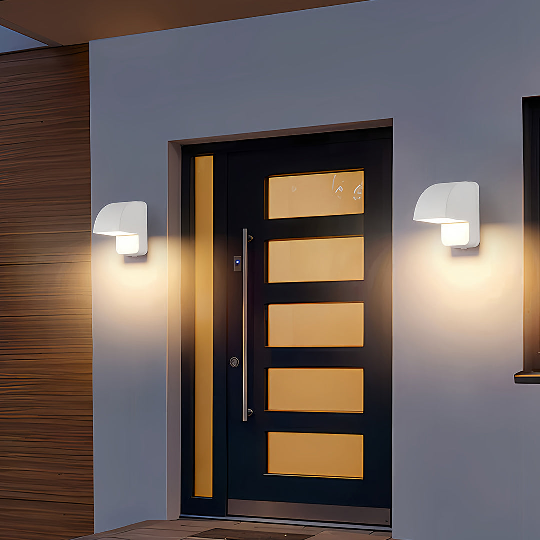 Wall industrial lights installed on dark exterior providing architectural accent lighting at night