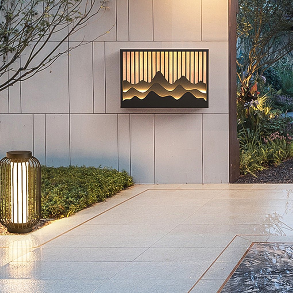 Wall mountain light illuminating a pathway with a decorative design.