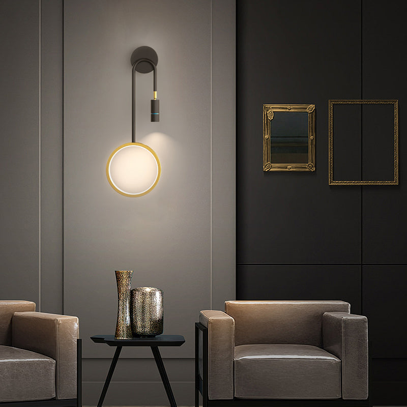 Wall pendant light with a sleek black frame, illuminating a modern living room with gray accents.