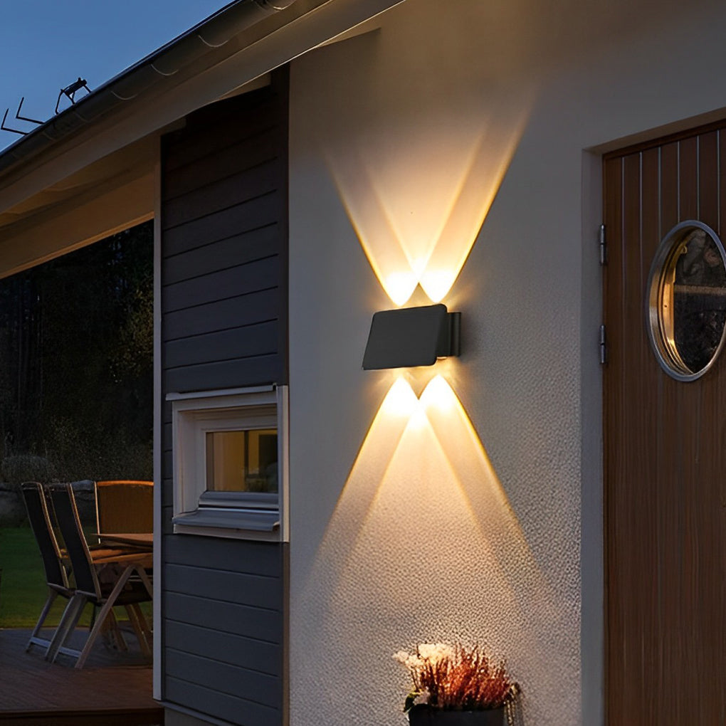 Wall sconce up and down light mounted beside entrance door with soft lighting.
