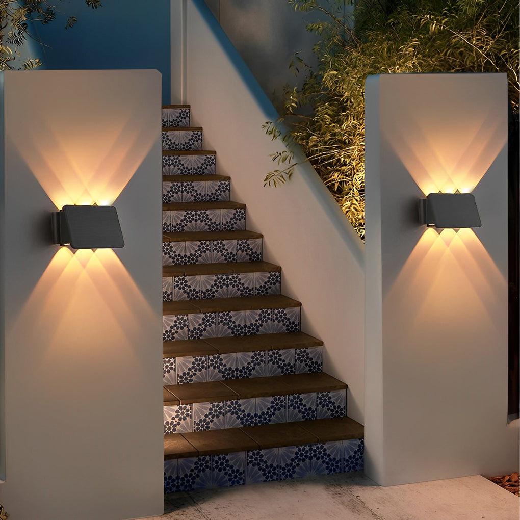 Wall sconce up and down light illuminating outdoor staircase with modern design.