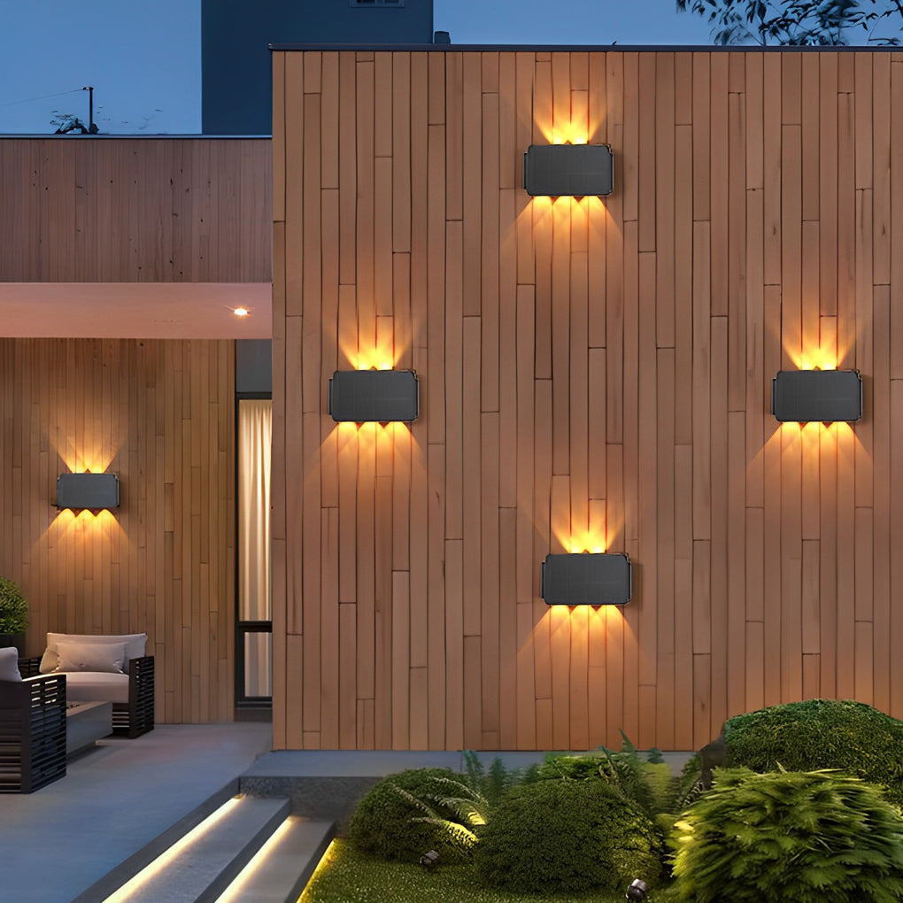 Wall sconce up and down light on wooden exterior wall with ambient glow.