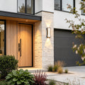 Close-up of wall up and down light showing warm dual-beam lighting effect on neutral wall.