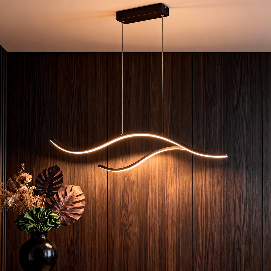 Warm curved LED pendant light creating ambient lighting against a dark wood wall.