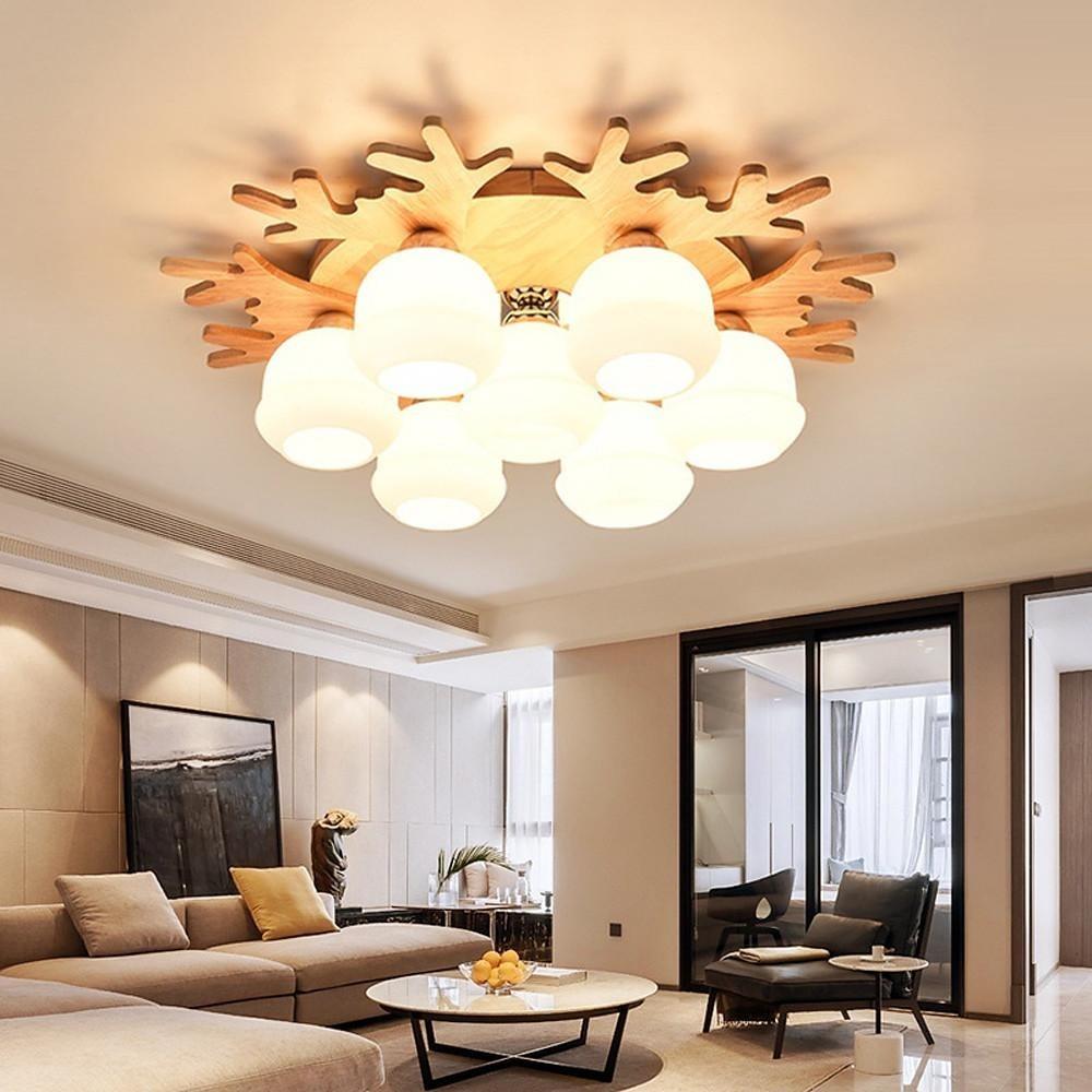 Warm light globe ceiling lamp featuring natural wood details and round glass globes in a cozy living room.