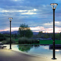 Waterfront lighting installation with decorative lamp posts reflecting in calm water at twilight