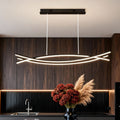 Wave hanging light installed above a modern dining table