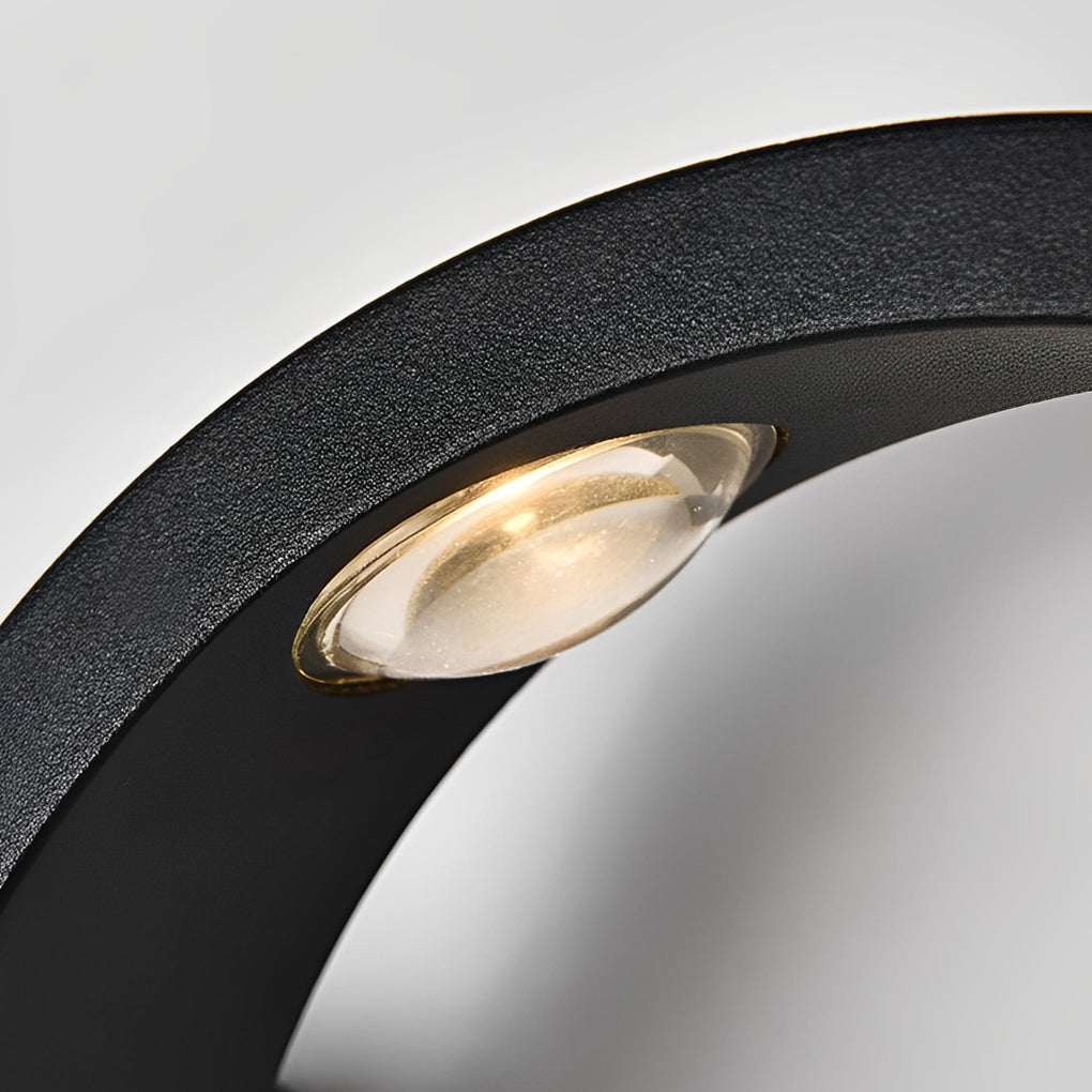 Weather-resistant wave wall sconce used outdoors in the rain, demonstrating durability and soft wall illumination.