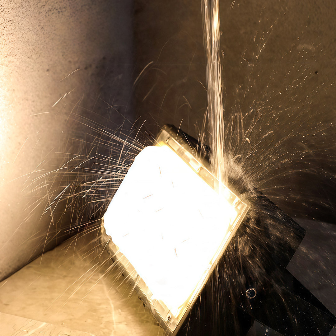 Weatherproof architectural flood lights fixture undergoing a water spray test to prove its durability and IP rating.