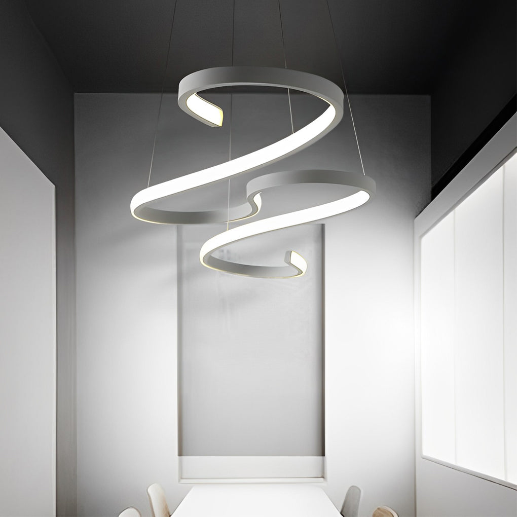 White chandeliers with a bold, abstract design, hanging above a conference table in an office.