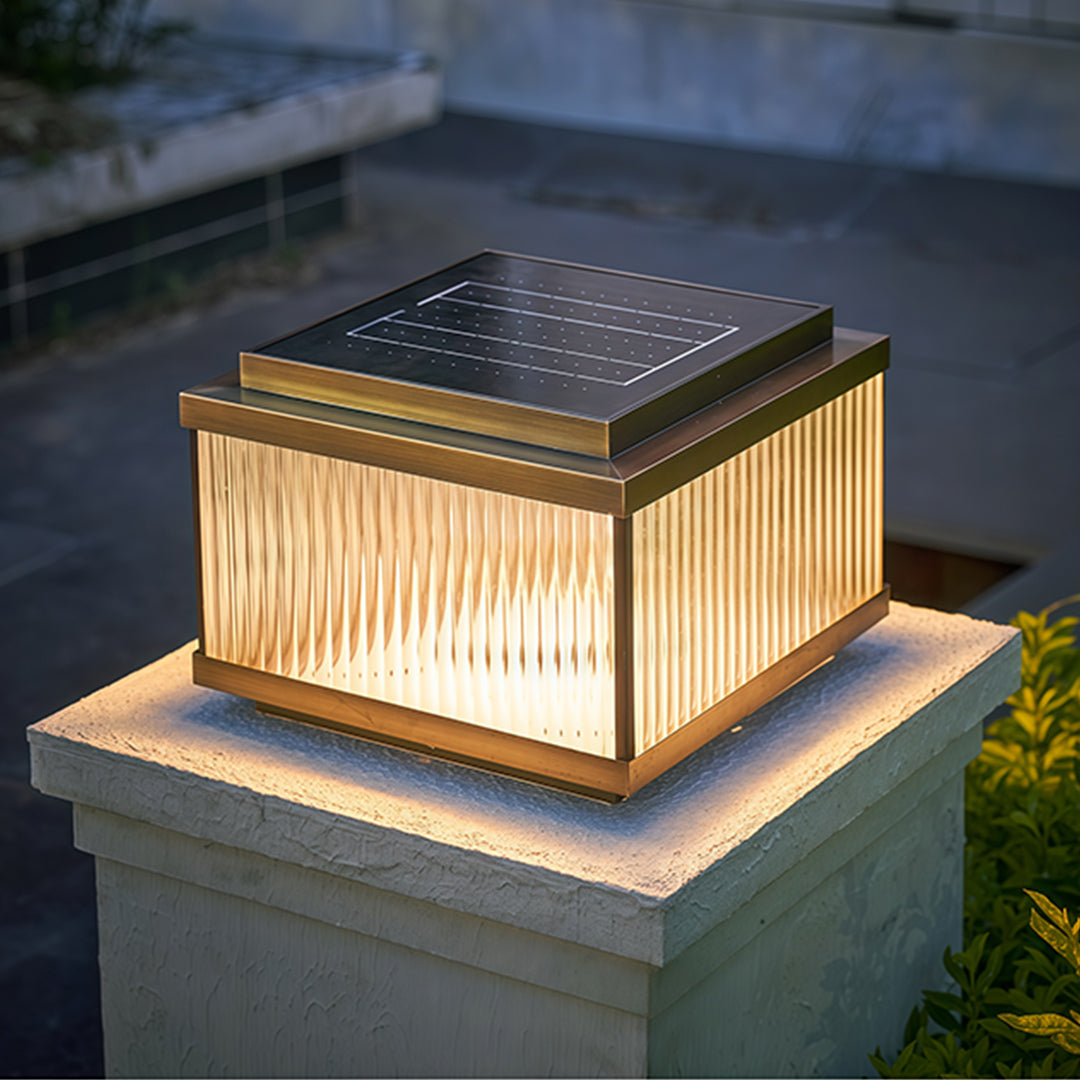 Cool white LED copper pillar light on concrete post showcasing modern minimalist outdoor lighting.