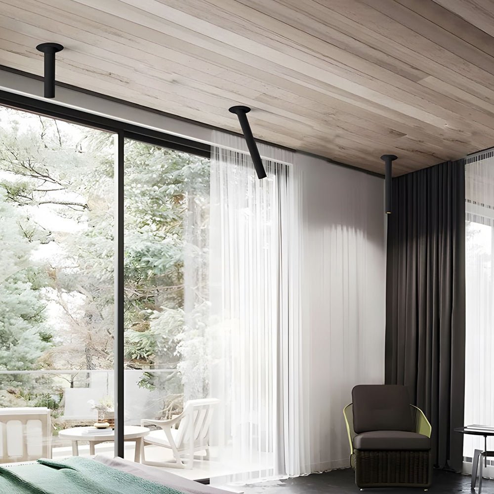 LED surface spotlights with white finish, mounted near large windows, offering flexible lighting in a stylish living space.