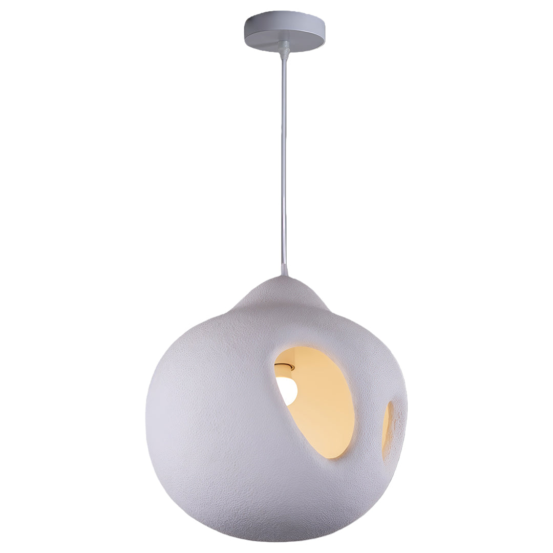White Nordic wabi sabi pendant light with hollow organic form and matte finish, hanging from ceiling.
