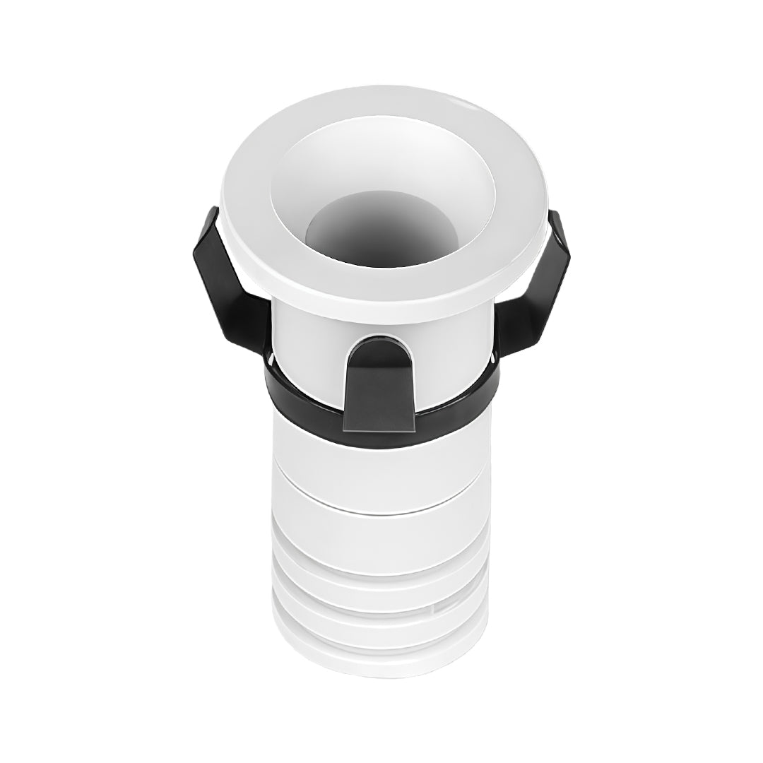 White recessed ceiling spotlight with chrome trim ring and ribbed housing for flush installation.