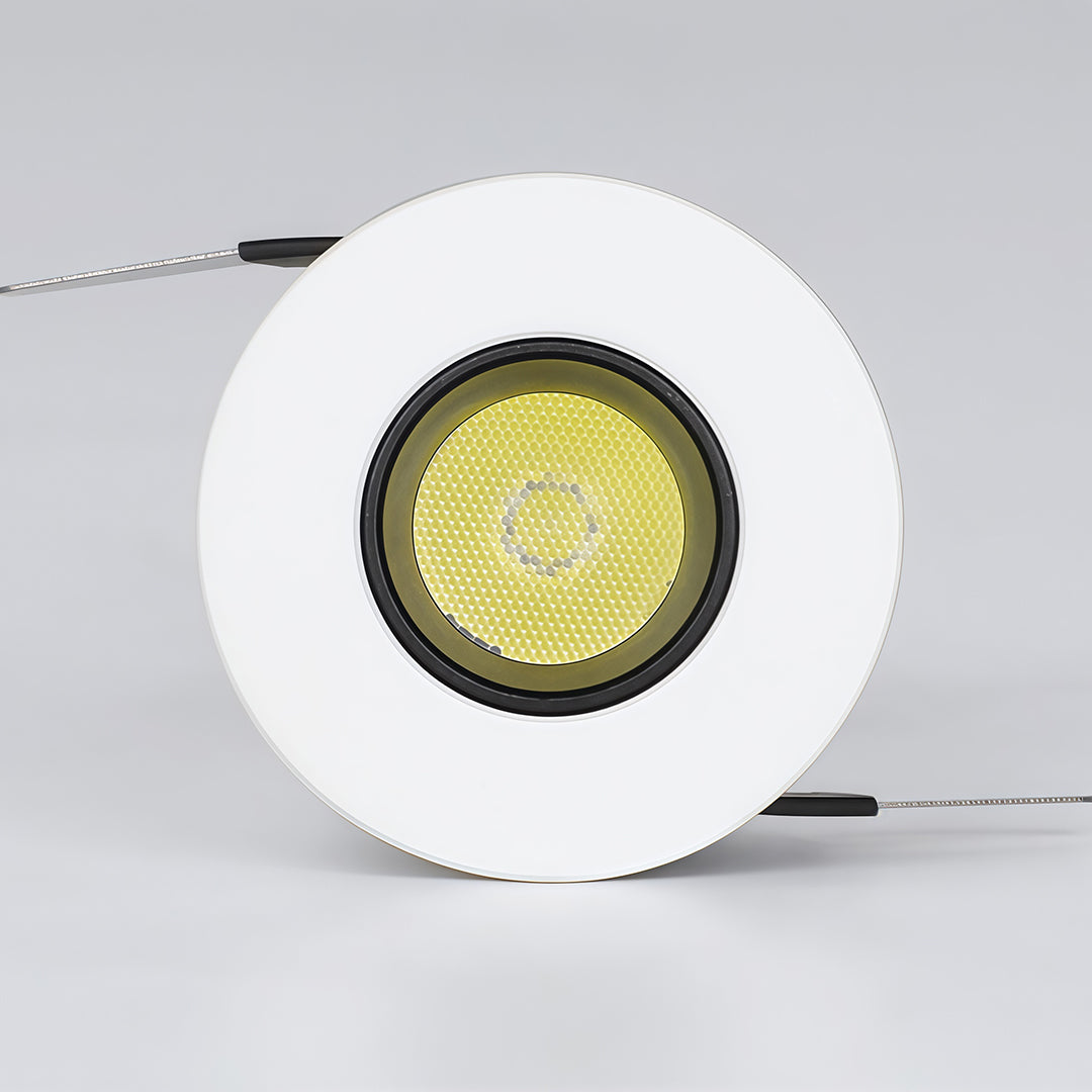 White recessed ceiling spotlight with yellow LED chip visible showing warm light output capability.