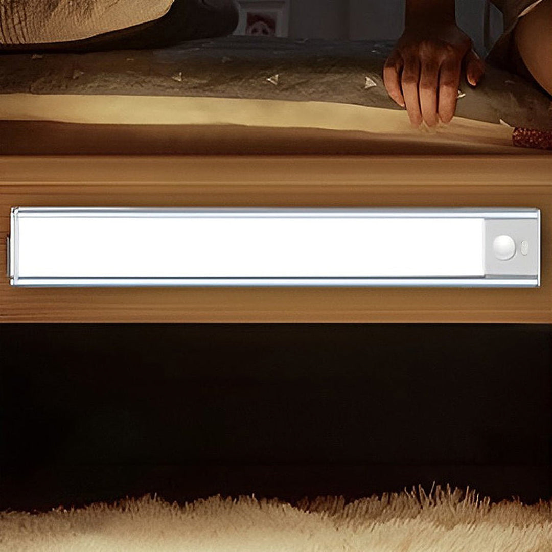 Detailed close up of a slim wireless under cabinet lighting fixture with a dimmer switch for brightness control.