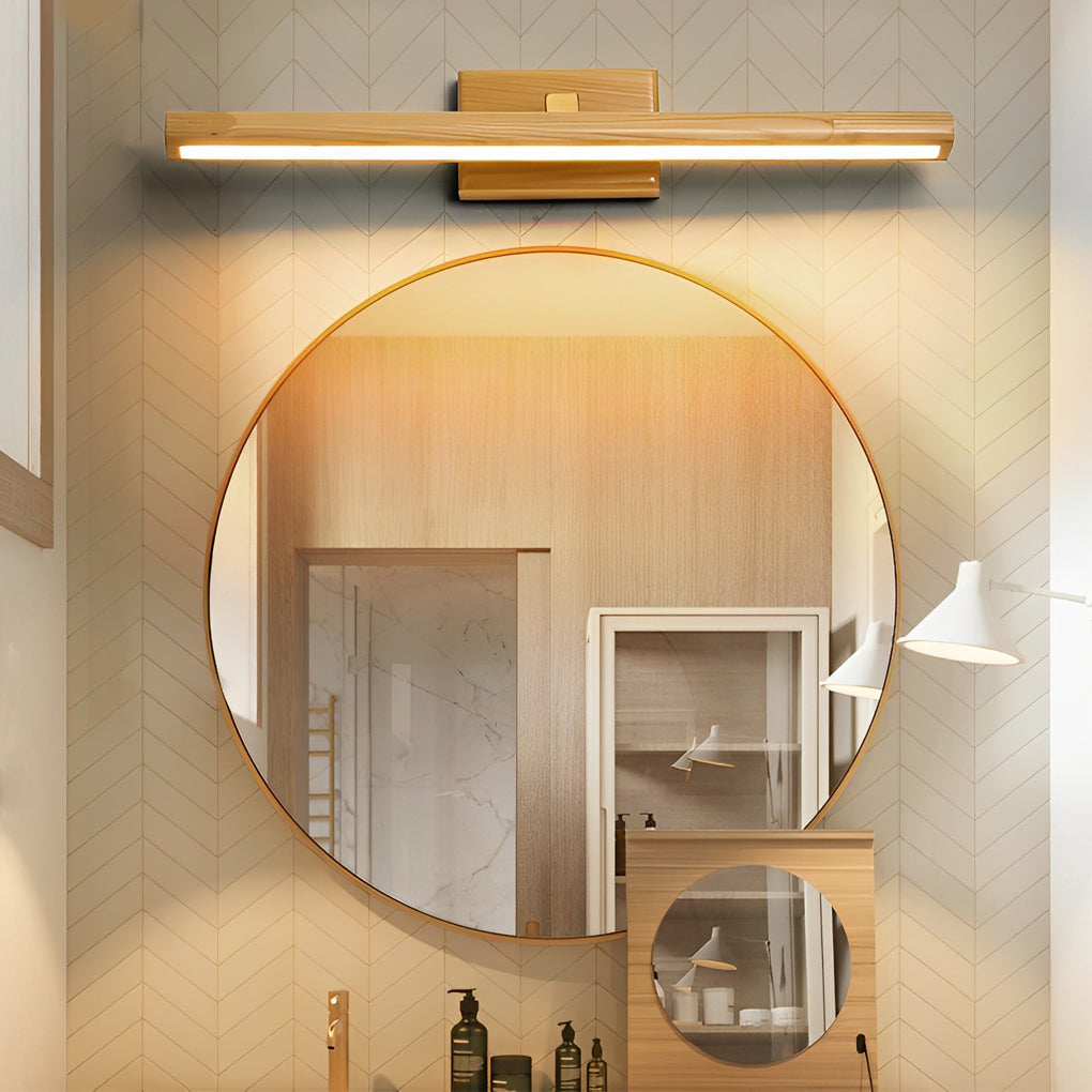 Wood bathroom vanity light installed above a round mirror in a modern bathroom.