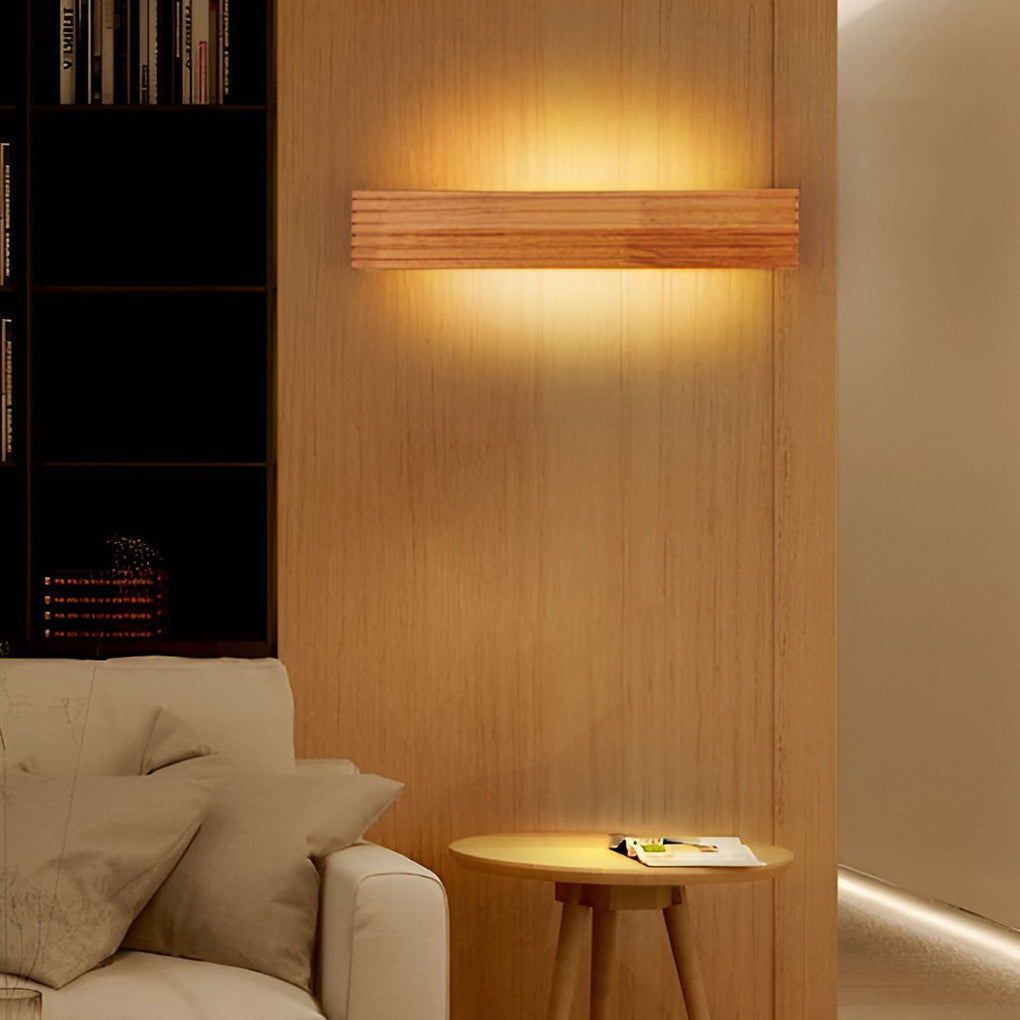 Wooden wall lamp placed beside a sofa, creating warm indirect lighting in a contemporary living room.