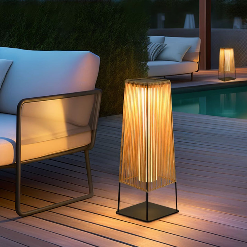 Woven floor lamp with a natural woven shade, illuminating a cozy outdoor lounge.