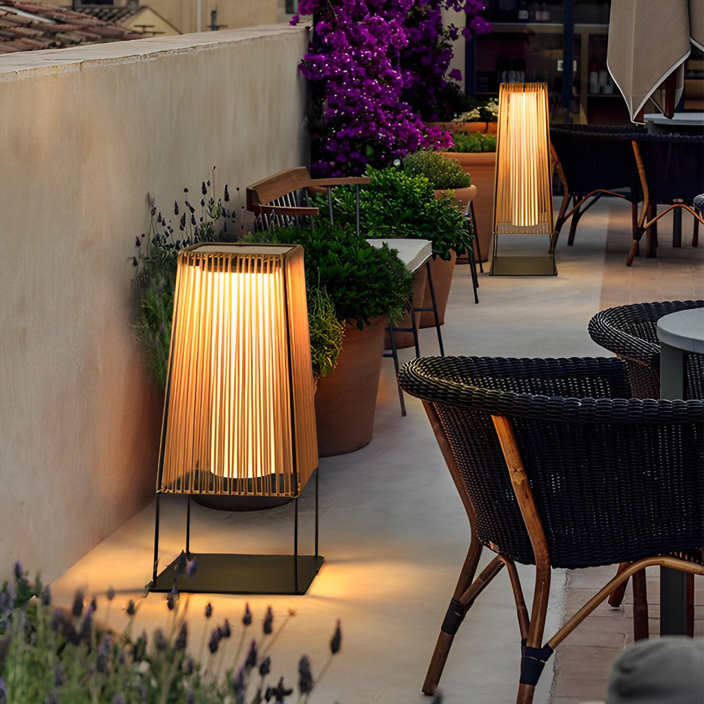 Woven floor lamp with a rustic design, providing ambient light near a pool.