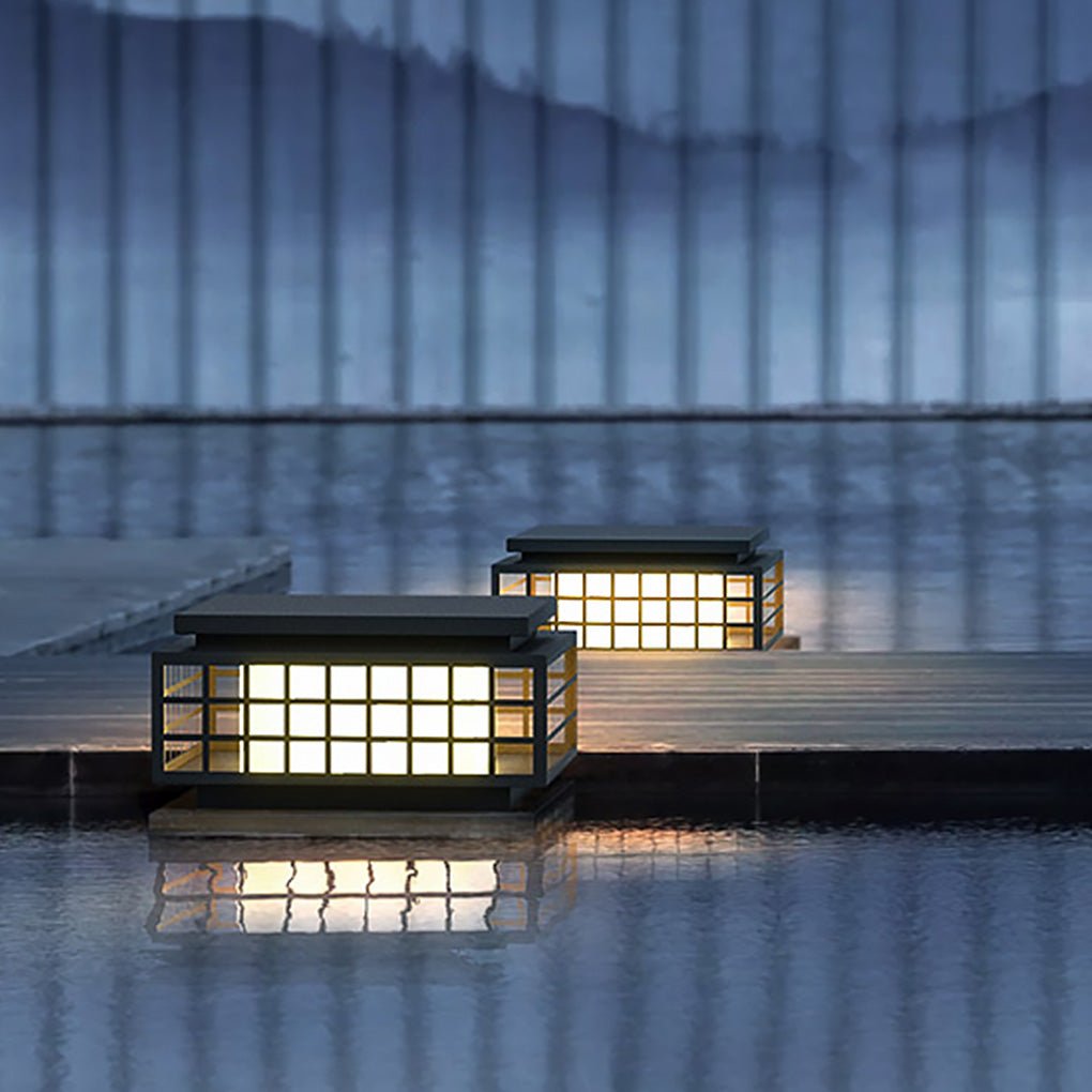 Zen garden light providing subtle light on a wooden deck at dusk.